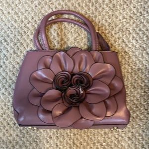 Lavender handbag with large flower detail.